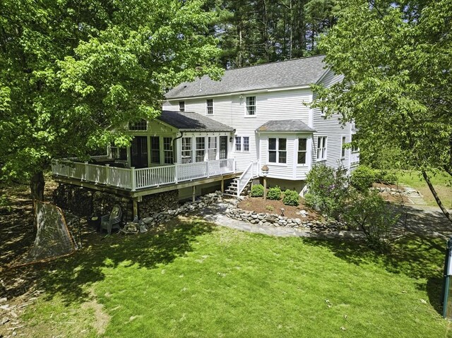 26 E St, Hopkinton, MA 01748 - back of property with a wooden deck, a shingled roof, and a yard