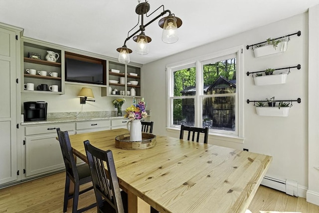 26 E St, Hopkinton, MA 01748 - dining space featuring a baseboard heating unit and light wood-style flooring