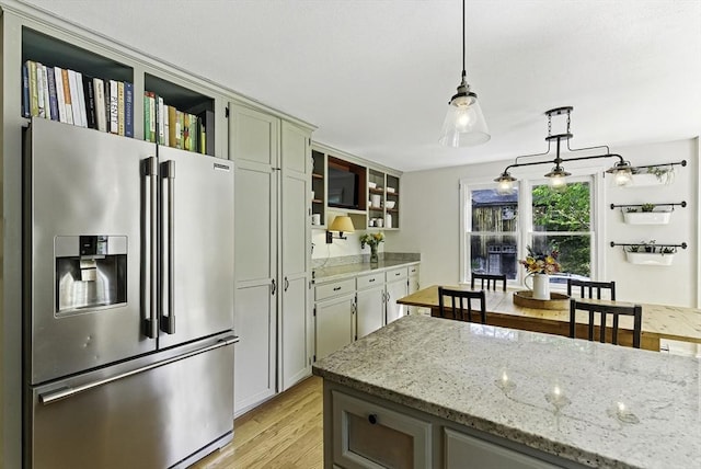 26 E St, Hopkinton, MA 01748 - kitchen with stainless steel refrigerator with ice dispenser, light wood-style flooring, pendant lighting, glass insert cabinets, and light stone counters
