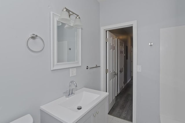 bathroom featuring vanity and toilet