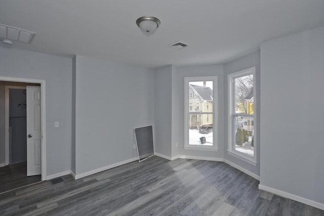 spare room with dark wood-type flooring