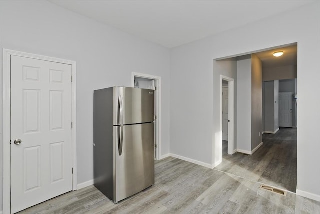 kitchen featuring stainless steel refrigerator and light wood-type flooring