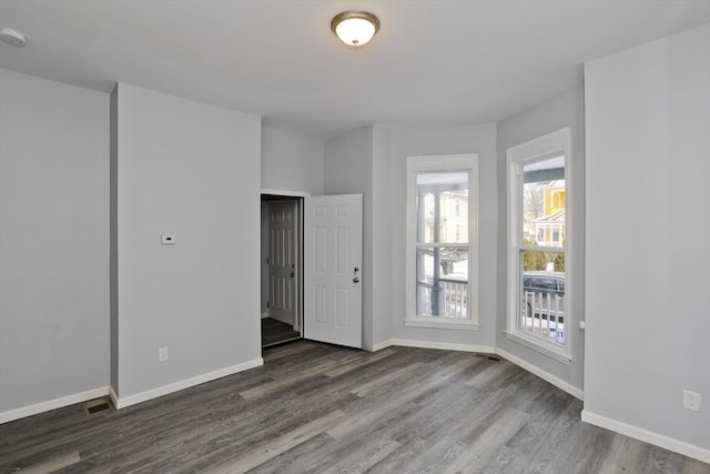 unfurnished room with dark hardwood / wood-style floors