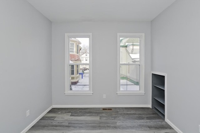 unfurnished room featuring dark hardwood / wood-style floors