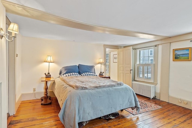 bedroom featuring radiator and light wood-type flooring