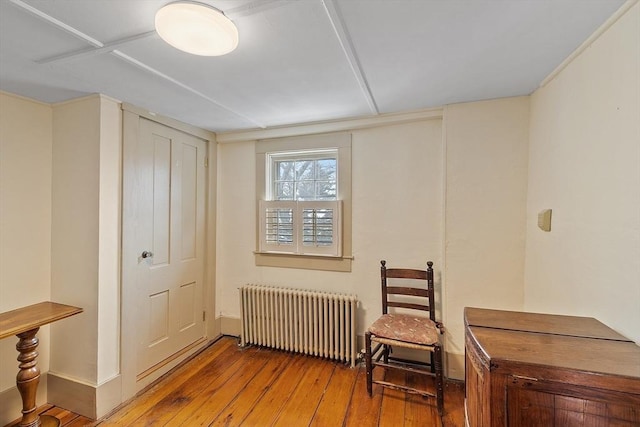 interior space featuring radiator and hardwood / wood-style flooring