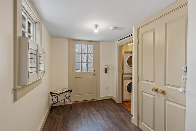 doorway with dark hardwood / wood-style flooring and stacked washer and clothes dryer