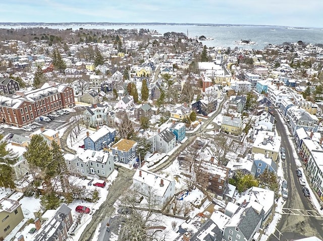 snowy aerial view featuring a water view