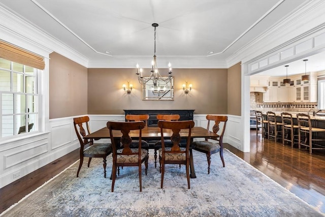 33 Old Concord Rd, Lincoln, MA 01773 - dining space featuring crown molding, wood finished floors, a wainscoted wall, an inviting chandelier, and a decorative wall