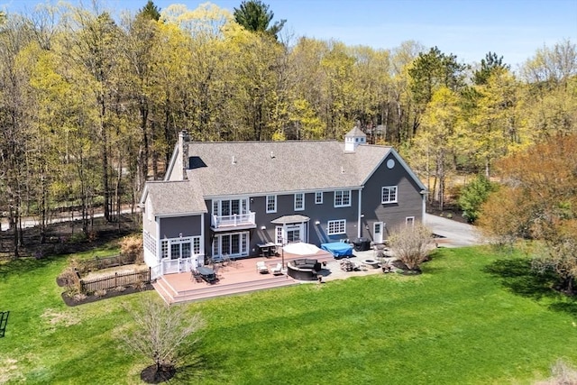 33 Old Concord Rd, Lincoln, MA 01773 - back of property featuring a lawn, a chimney, a deck, and french doors
