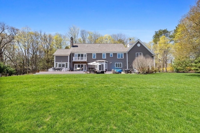33 Old Concord Rd, Lincoln, MA 01773 - back of house featuring a lawn, a chimney, and a deck