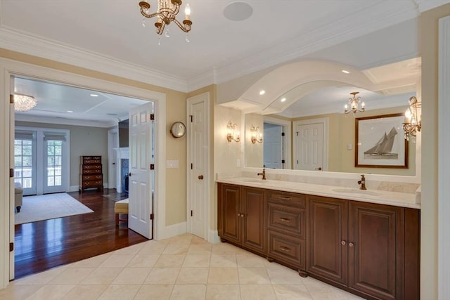 33 Old Concord Rd, Lincoln, MA 01773 - bathroom featuring crown molding, double vanity, a notable chandelier, and a sink