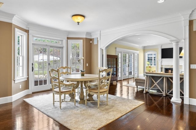 33 Old Concord Rd, Lincoln, MA 01773 - dining room featuring baseboards, a lit fireplace, recessed lighting, hardwood / wood-style flooring, and arched walkways