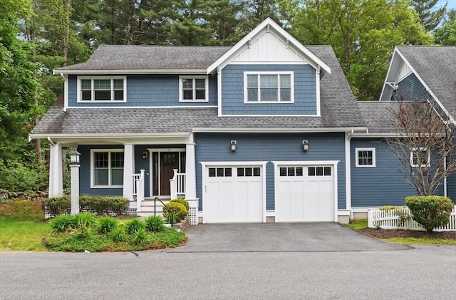 15 Village Ln Unit 15, Wayland, MA 01778 - view of front of house featuring a shingled roof, driveway, a garage, and a porch