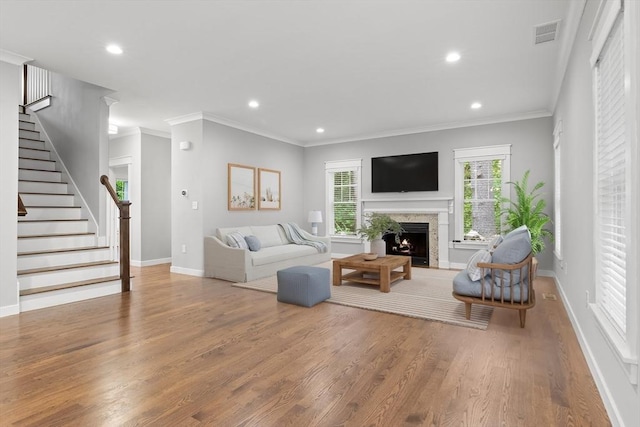 15 Village Ln Unit 15, Wayland, MA 01778 - living room featuring wood finished floors, stairway, a warm lit fireplace, recessed lighting, and crown molding