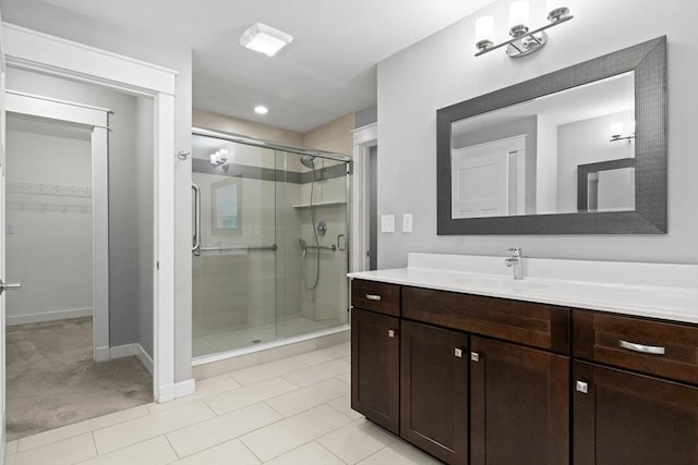 15 Village Ln Unit 15, Wayland, MA 01778 - bathroom with a stall shower, vanity, a walk in closet, and tile patterned flooring
