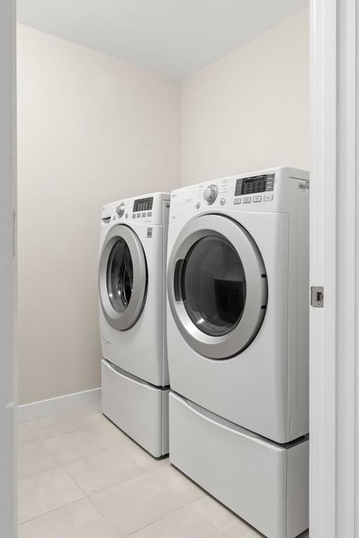 15 Village Ln Unit 15, Wayland, MA 01778 - laundry room with washer and dryer and light tile patterned floors