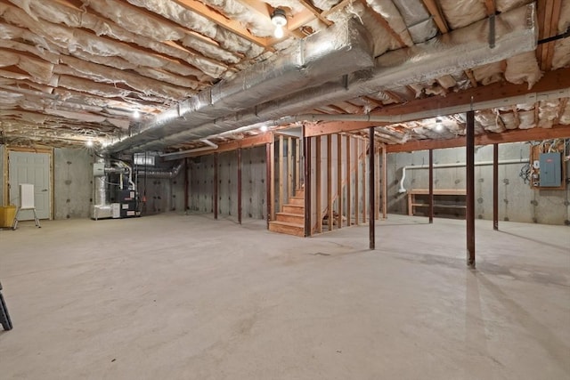 15 Village Ln Unit 15, Wayland, MA 01778 - unfinished below grade area with electric panel, heating unit, and stairway