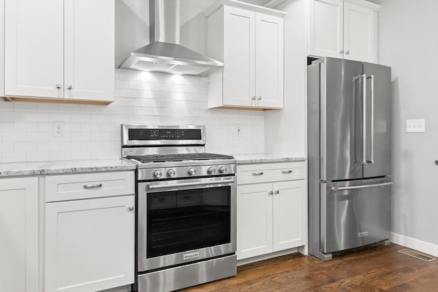 15 Village Ln Unit 15, Wayland, MA 01778 - kitchen with appliances with stainless steel finishes, wall chimney exhaust hood, dark wood-style floors, white cabinetry, and light stone countertops