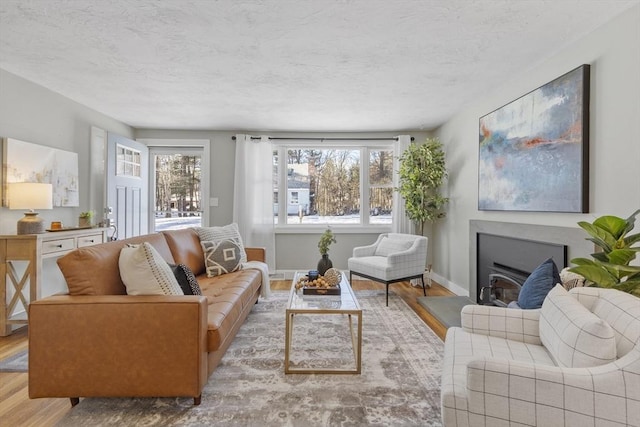 living room featuring a textured ceiling and light hardwood / wood-style floors