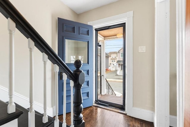 entryway with dark wood-style floors and stairway