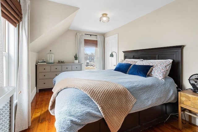 bedroom with lofted ceiling and hardwood / wood-style floors