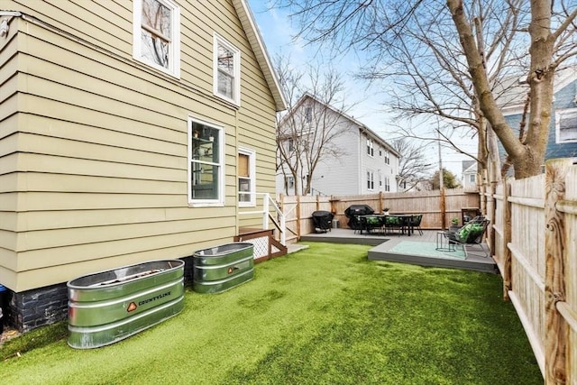 view of yard featuring a patio area and a fenced backyard