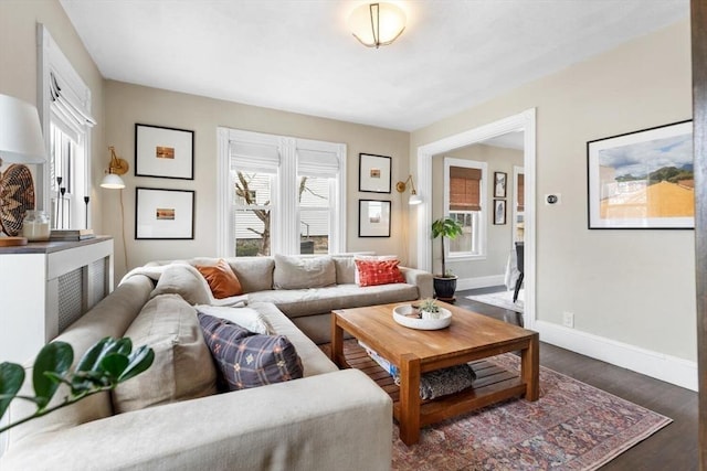 living room with dark wood-style flooring and baseboards