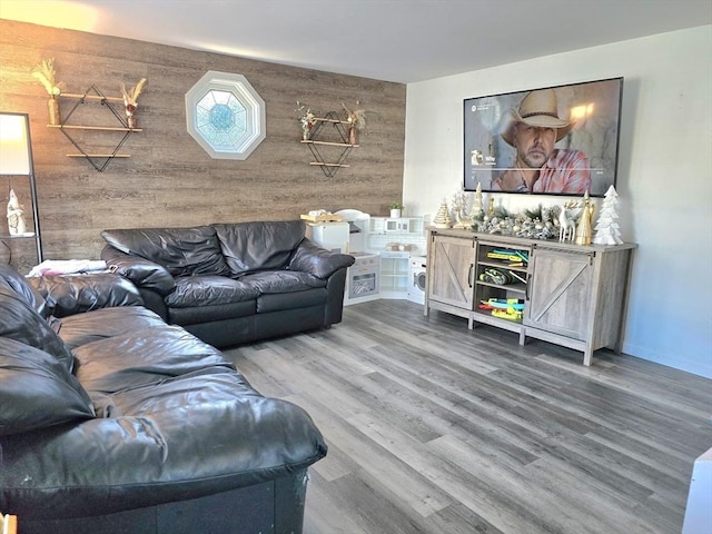 living room with wood walls and hardwood / wood-style flooring