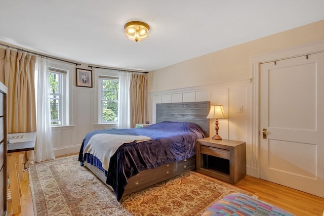 8 Colbourne Cres Unit 1, Brookline, MA 02445 - bedroom with light wood finished floors and a decorative wall
