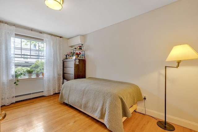 8 Colbourne Cres Unit 1, Brookline, MA 02445 - bedroom featuring a baseboard heating unit, an AC wall unit, wood finished floors, and baseboards