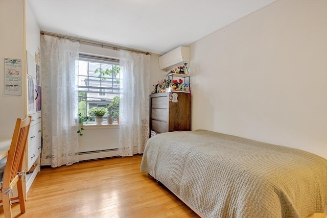 8 Colbourne Cres Unit 1, Brookline, MA 02445 - bedroom featuring light wood-style flooring, a wall mounted AC, and a baseboard heating unit