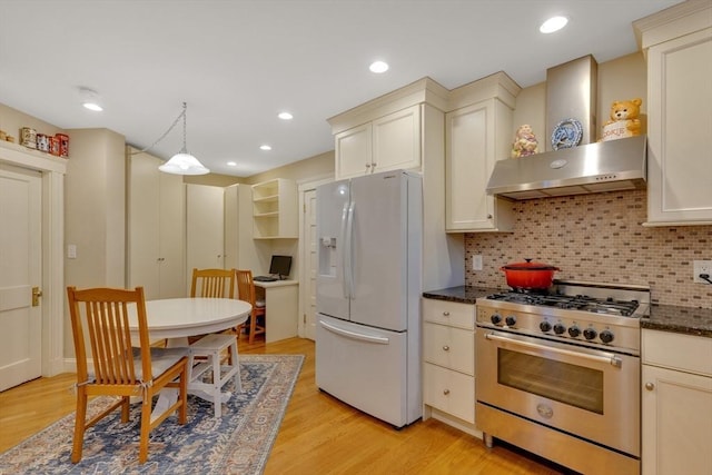 8 Colbourne Cres Unit 1, Brookline, MA 02445 - kitchen featuring white refrigerator with ice dispenser, stainless steel stove, backsplash, light wood-type flooring, and recessed lighting