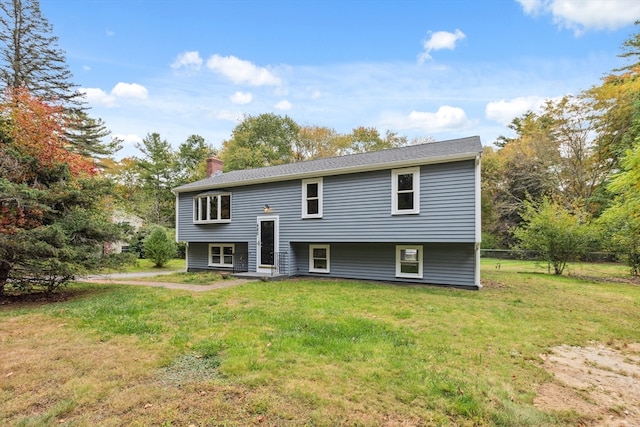 back of property featuring a lawn