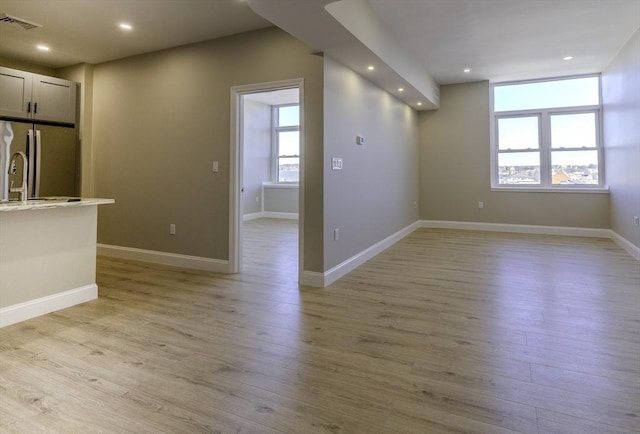 unfurnished room featuring light wood-style floors, baseboards, and recessed lighting