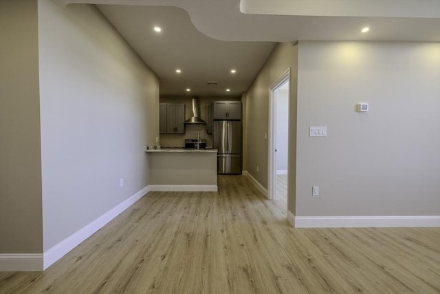 interior space with recessed lighting, light wood-style flooring, and baseboards