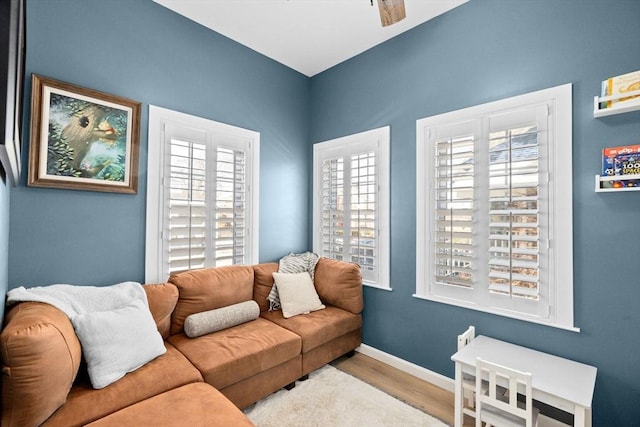 living room with ceiling fan and light wood-type flooring