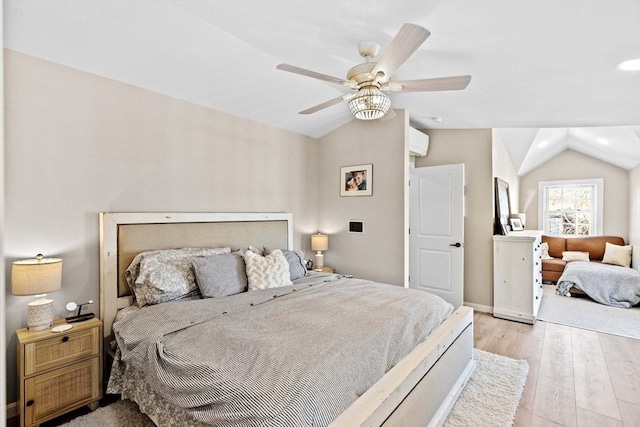 bedroom featuring ceiling fan, lofted ceiling, light hardwood / wood-style floors, and a wall unit AC