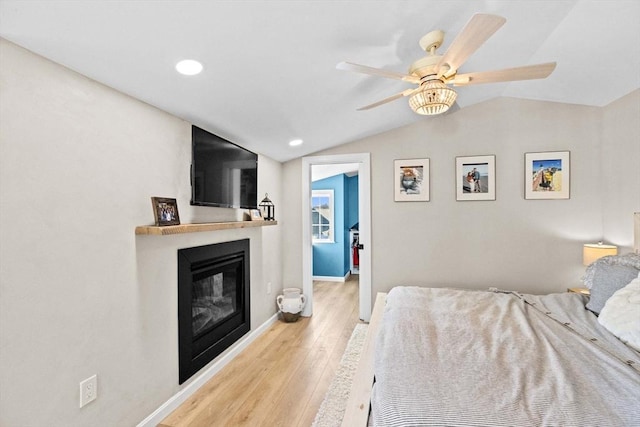 bedroom featuring ceiling fan, lofted ceiling, and light hardwood / wood-style floors