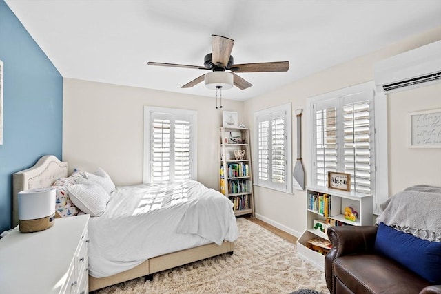 bedroom featuring ceiling fan, a wall mounted AC, and multiple windows