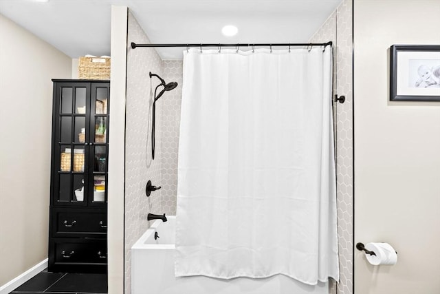 bathroom with shower / bathtub combination with curtain and tile patterned floors