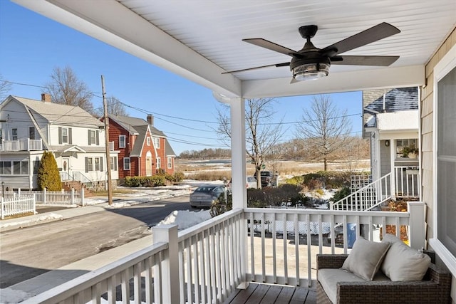 balcony featuring ceiling fan and a porch