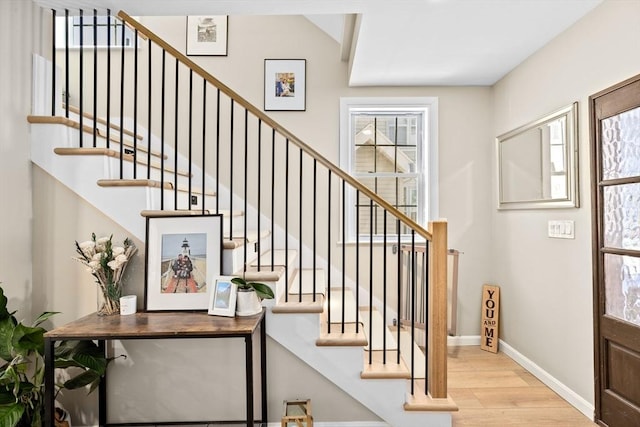 stairs featuring hardwood / wood-style floors