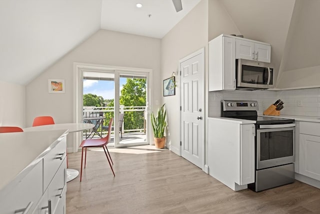 870 S S Unit 3, Boston, MA 02131 - kitchen with appliances with stainless steel finishes, lofted ceiling, light wood-type flooring, tasteful backsplash, and white cabinets