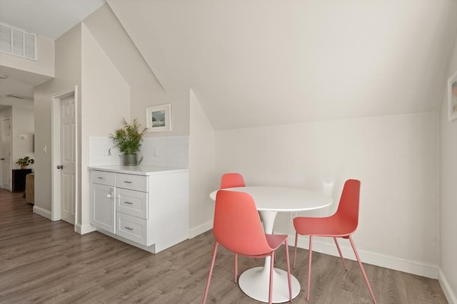 870 S S Unit 3, Boston, MA 02131 - dining space featuring light wood-style floors, lofted ceiling, and baseboards