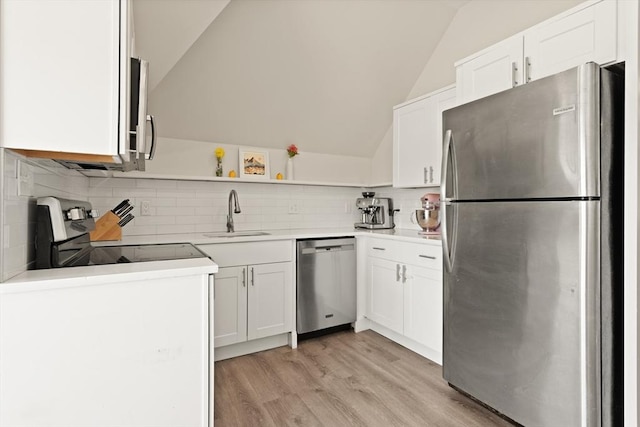 870 S S Unit 3, Boston, MA 02131 - kitchen with appliances with stainless steel finishes, vaulted ceiling, a sink, decorative backsplash, and white cabinetry