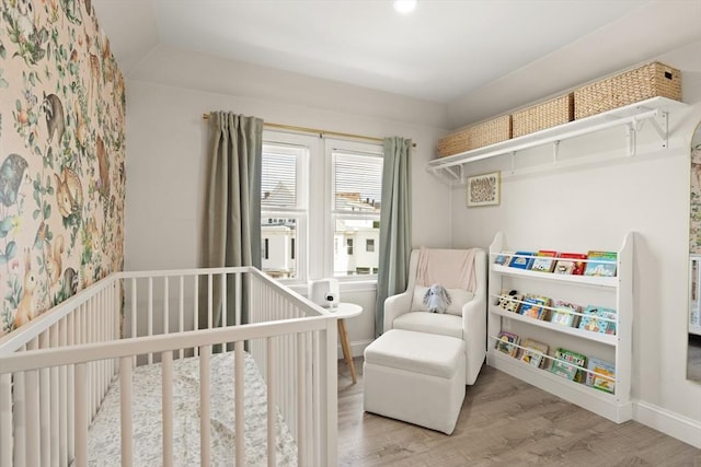 870 S S Unit 3, Boston, MA 02131 - bedroom featuring a nursery area, wood finished floors, wallpapered walls, and baseboards