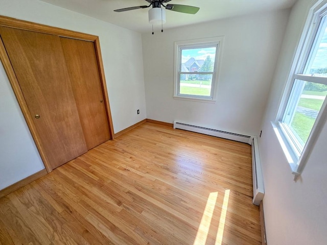 264 Dresser Hill Rd, Dudley, MA 01571 - unfurnished bedroom featuring a baseboard radiator, light wood finished floors, a closet, and baseboards