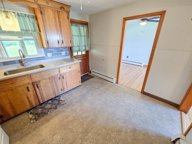 264 Dresser Hill Rd, Dudley, MA 01571 - kitchen with a sink, a baseboard heating unit, light countertops, ceiling fan, and a wainscoted wall