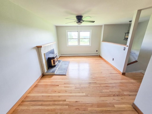 264 Dresser Hill Rd, Dudley, MA 01571 - unfurnished living room with wood finished floors, ceiling fan, baseboard heating, a brick fireplace, and baseboards